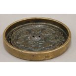 A small Chinese bronze mirror. 10 cm diameter.