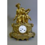 A 19th century gilt mantle clock surmounted with a woman and a putto. 41 cm high.