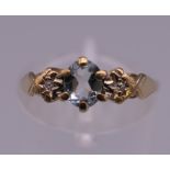 A 9 ct gold three stone diamond and aquamarine ring. Ring size J/K.