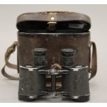 A cased pair of 1942 German binoculars. The case 15.5 cm high.