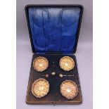 A cased set of four silver gilt salts. Each 6 cm diameter.