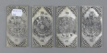 A set of four scroll weights.