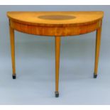 A 19th century inlaid satinwood demi lune side table. 97 cm wide.