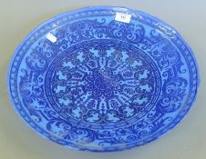 A Turkish blue glass bowl. 39.5 cm diameter.