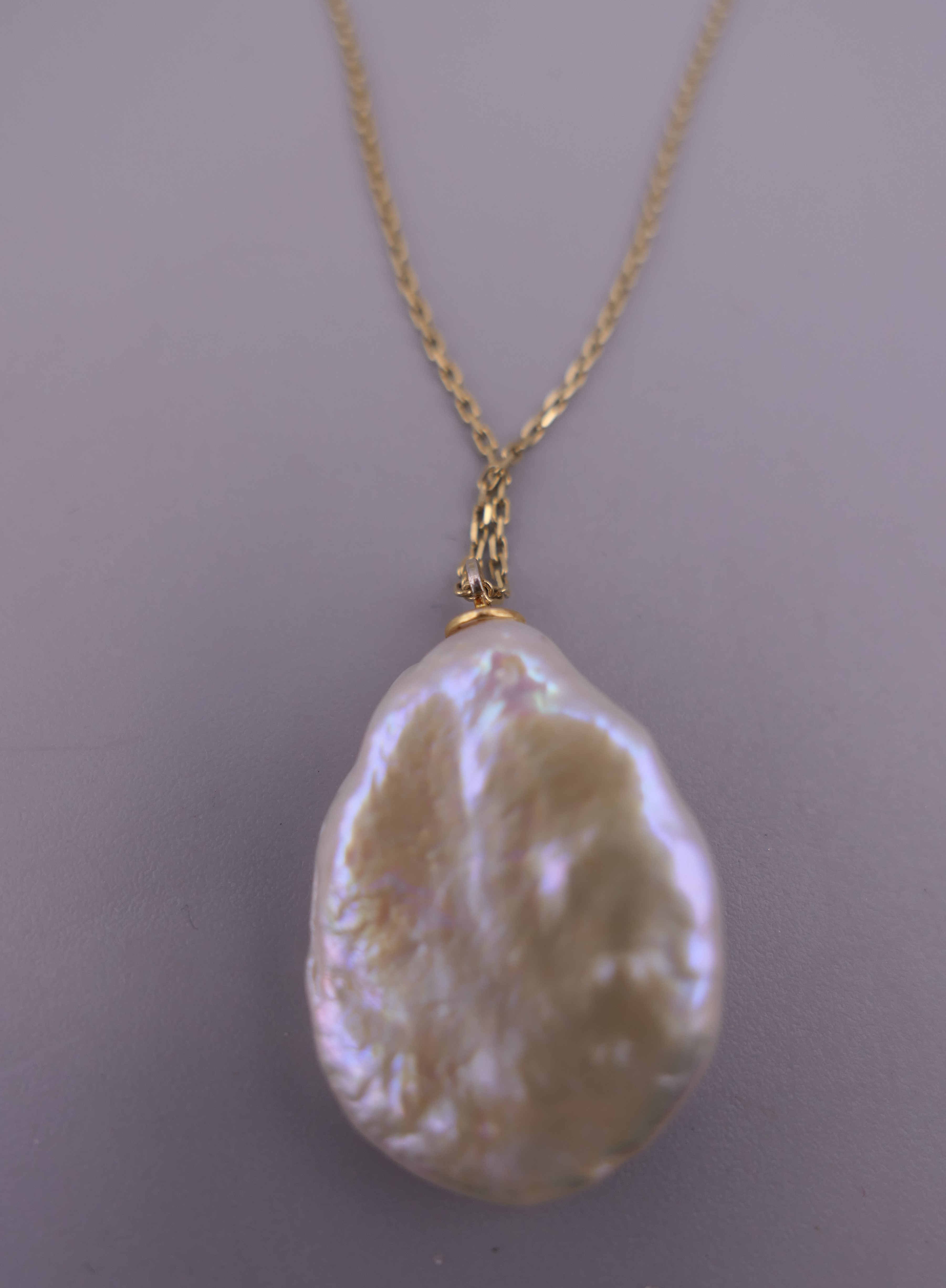 A stone set mother-of-pearl pendant mounted on a silver gilt chain. The pendant 2.5 cm high. - Image 2 of 6
