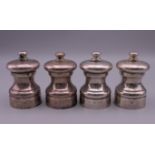 Two pairs of silver salts and pepper grinders. 7 cm high.