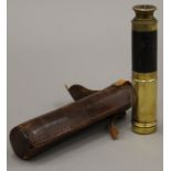 A small early 20th century brass and leather telescope, in leather case. 45.
