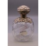 A silver topped bulbous perfume bottle. 12 cm high.