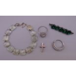 A silver jade bracelet, two silver rings, a silver cross and silver brooch.