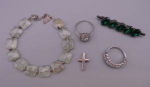 A silver jade bracelet, two silver rings, a silver cross and silver brooch.