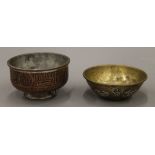 A tinned copper bowl with Arabic inscriptions and a Cairo Ware bowl with silver and copper