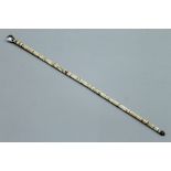 A shark vertebrae swagger stick. 62.5 cm long.