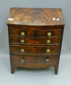 A 19th century mahogany miniature bow front chest of drawers. 43 cm wide, 27.5 cm deep, 54 cm high.