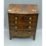 A 19th century mahogany miniature bow front chest of drawers. 43 cm wide, 27.5 cm deep, 54 cm high.