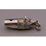 A silver whistle formed as a fox. 4.5 cm long.