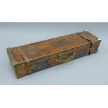 A William Evans brass mounted leather double gun case. 85.5 cm long.