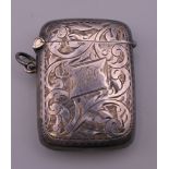 A George V silver vesta engraved with foliage, hallmarked for Henry Williamson Ltd, Birmingham,