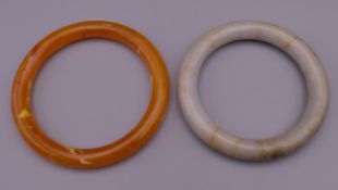 A jade bangle and another. The former 6 cm inner diameter.