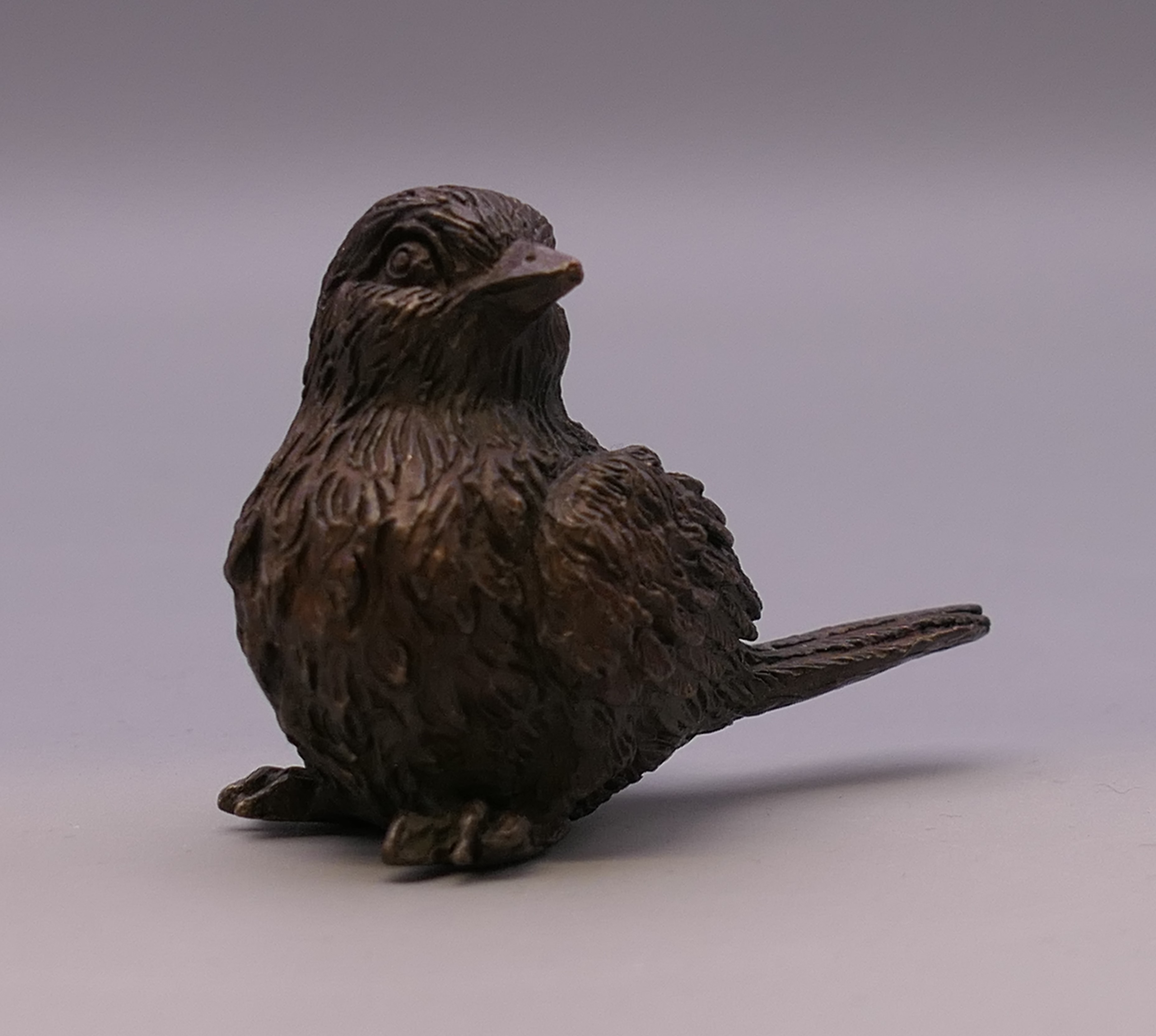 A bronze model of a bird. 4 cm high.