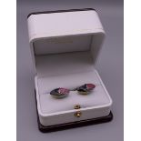 A pair of Hackett of London rugby ball cufflinks. 2 cm wide.