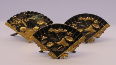 Three 19th century Japanese fan shaped menu holders. The largest 6 cm wide.