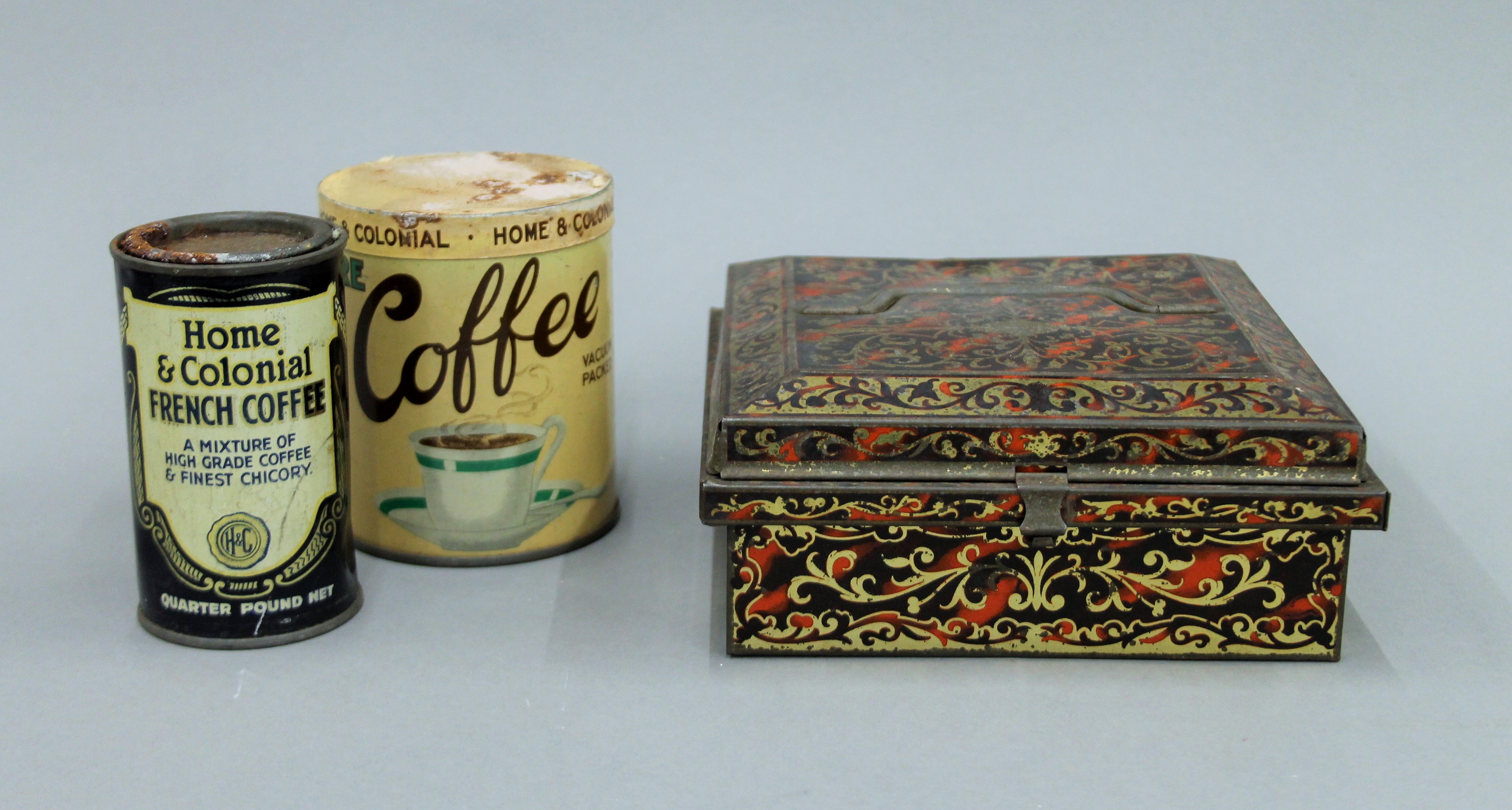 Three vintage tins, two with their original contents.