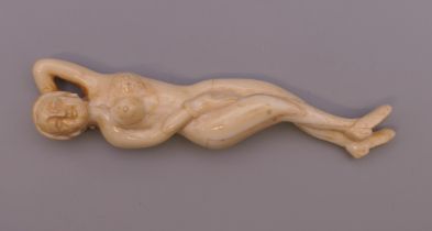 A carved bone medical figure. 12.5 cm long.