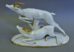 A German gilt decorated porcelain model of antelope.