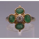 A 9 ct gold emerald and diamond ring. Ring size O.