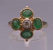 A 9 ct gold emerald and diamond ring. Ring size O.