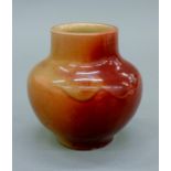 A small glazed stoneware vase. 11 cm high.