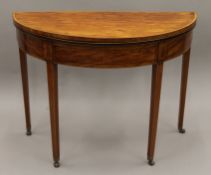 A Georgian satinwood crossbanded sabicu demi lune tea table. 98 cm wide.