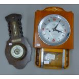 An oak barometer and a wall clock.