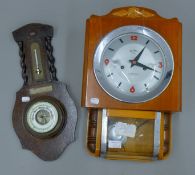 An oak barometer and a wall clock.