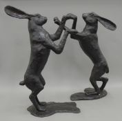 A pair of large bronze boxing hares. The largest 83 cm high.