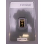 A Heraeus 1 gram fine gold bar.