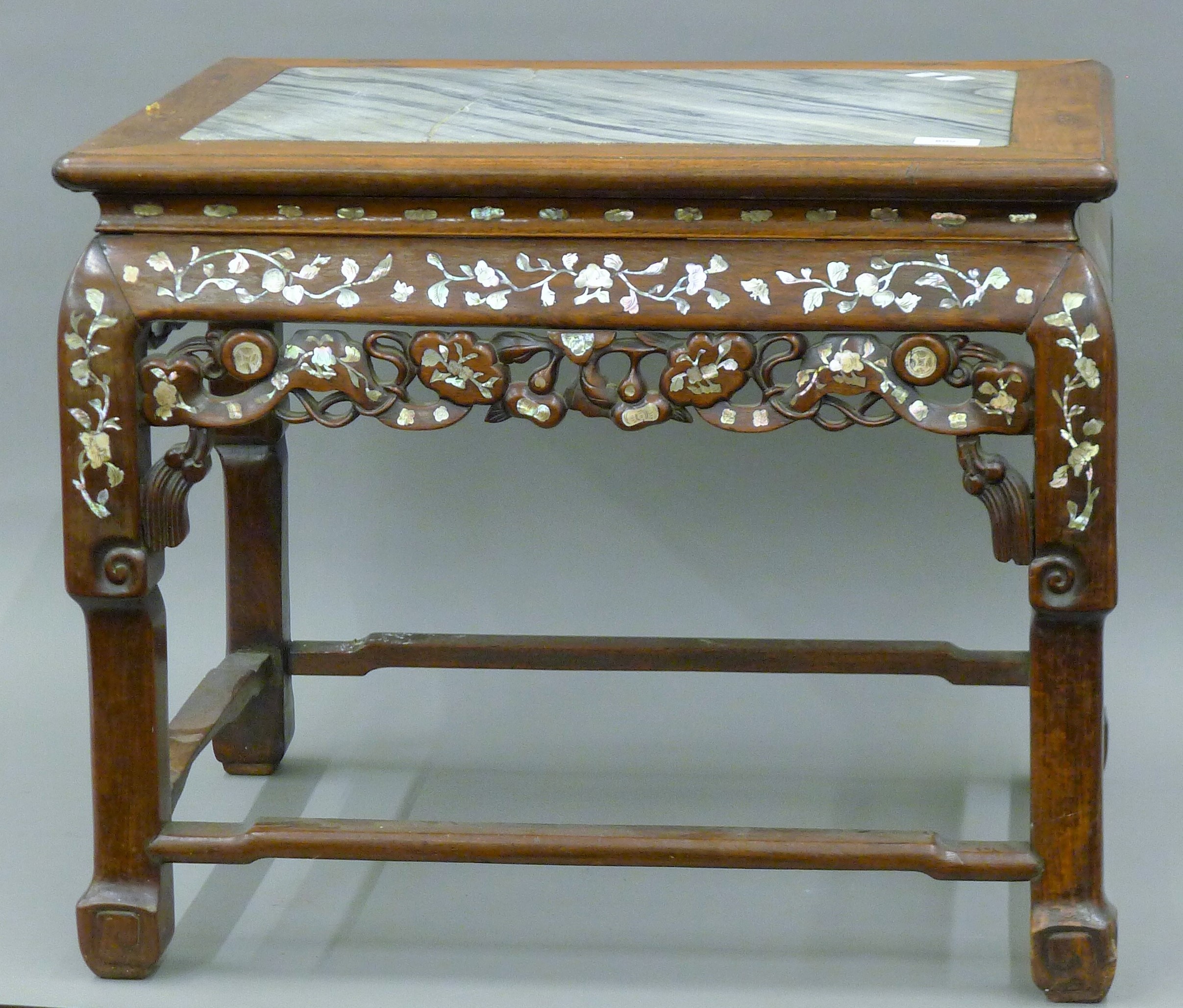 A 19th century Chinese mother-of-pearl inlaid marble topped low table (adapted from a chair). 62.