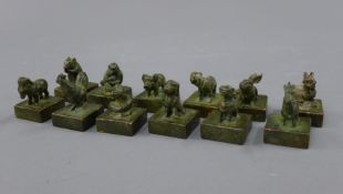 A set of twelve bronze seals. Each approximately 3 cm high.