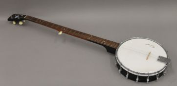 A post-war British John Grey long neck five string bluegrass banjo in a hard case bearing the grey