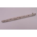 An Edwardian platinum twenty-one diamond bar brooch. Approximately 1.5 carats of diamonds. 7.