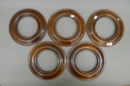 Five mahogany oval frames. 25.5 cm diameter.