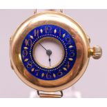 A 14 ct gold and enamel half hunter wristwatch on a 9 ct gold bracelet. 4 cm wide. 41.