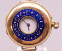 A 14 ct gold and enamel half hunter wristwatch on a 9 ct gold bracelet. 4 cm wide. 41.