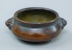 A small bronze censer with fo dog handles. 12 cm wide.