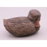 A Japanese carved model of a duck. 8.5 cm long.