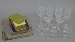 A quantity of cut glass drinking glasses and four vintage books.