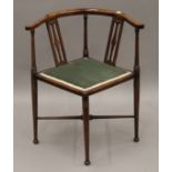 An Edwardian inlaid mahogany corner chair. 62 cm wide.