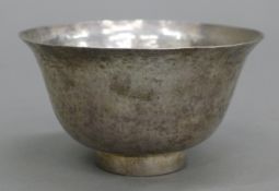 A beaten white metal bowl. 10 cm diameter.