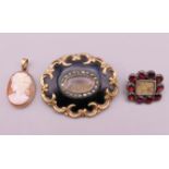 Two 19th century mourning brooches and a cameo pendant. Largest brooches 4.25 cm x 3.5 cm.