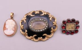 Two 19th century mourning brooches and a cameo pendant. Largest brooches 4.25 cm x 3.5 cm.